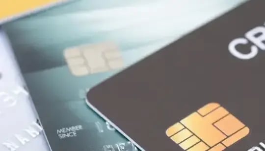 Three credit and debit cards on top of each another. 